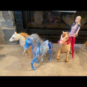 Toy horses and barbie doll.
